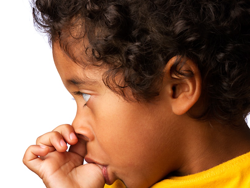 A young child sucking their thumb.